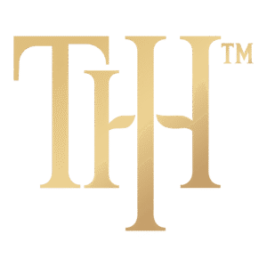 The Hustle Is Holy official gold THIH monogram logo — faith-driven lifestyle brand emblem.