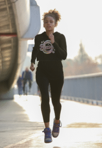 cropped hoodie mockup featuring a young woman running 40181 r el2 The Milestones The Message The Ministry